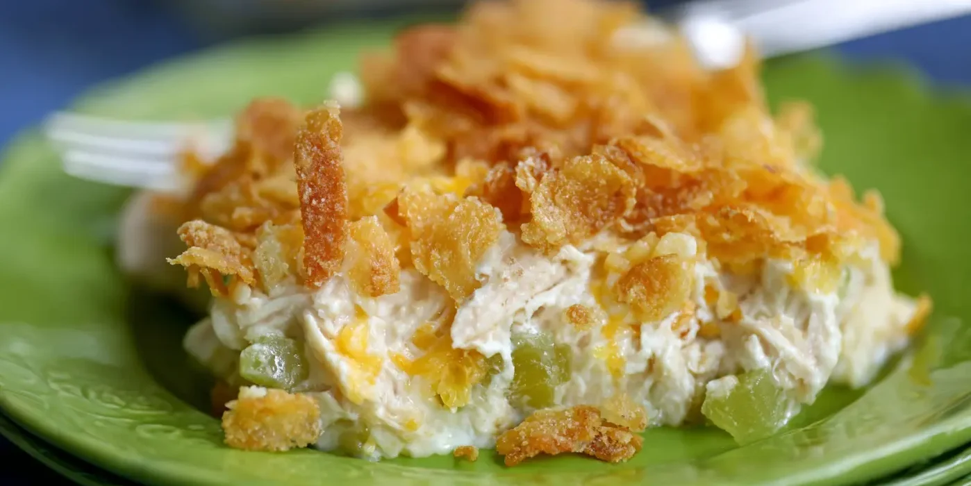 Appetizing rotisserie chicken recipes casserole with a golden-brown crispy topping served on a vibrant green plate.