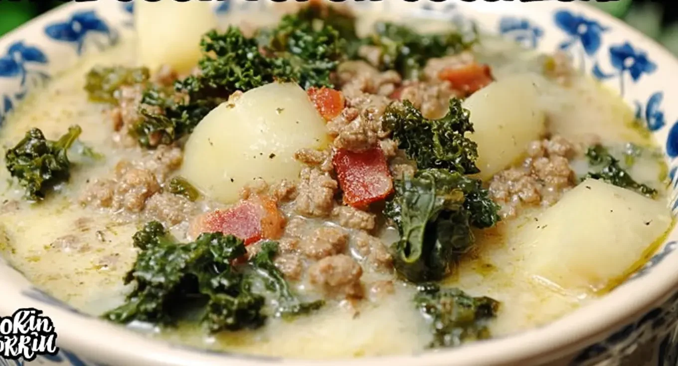 A close-up, top-down view of a hearty bowl of creamy zuppa toscana soup, similar to Olive Garden's, perfect for a crockpot, featuring sausage, potatoes, kale, and bacon in a rustic blue floral bowl.